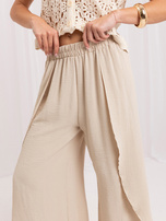 Beige summer pants with slits.