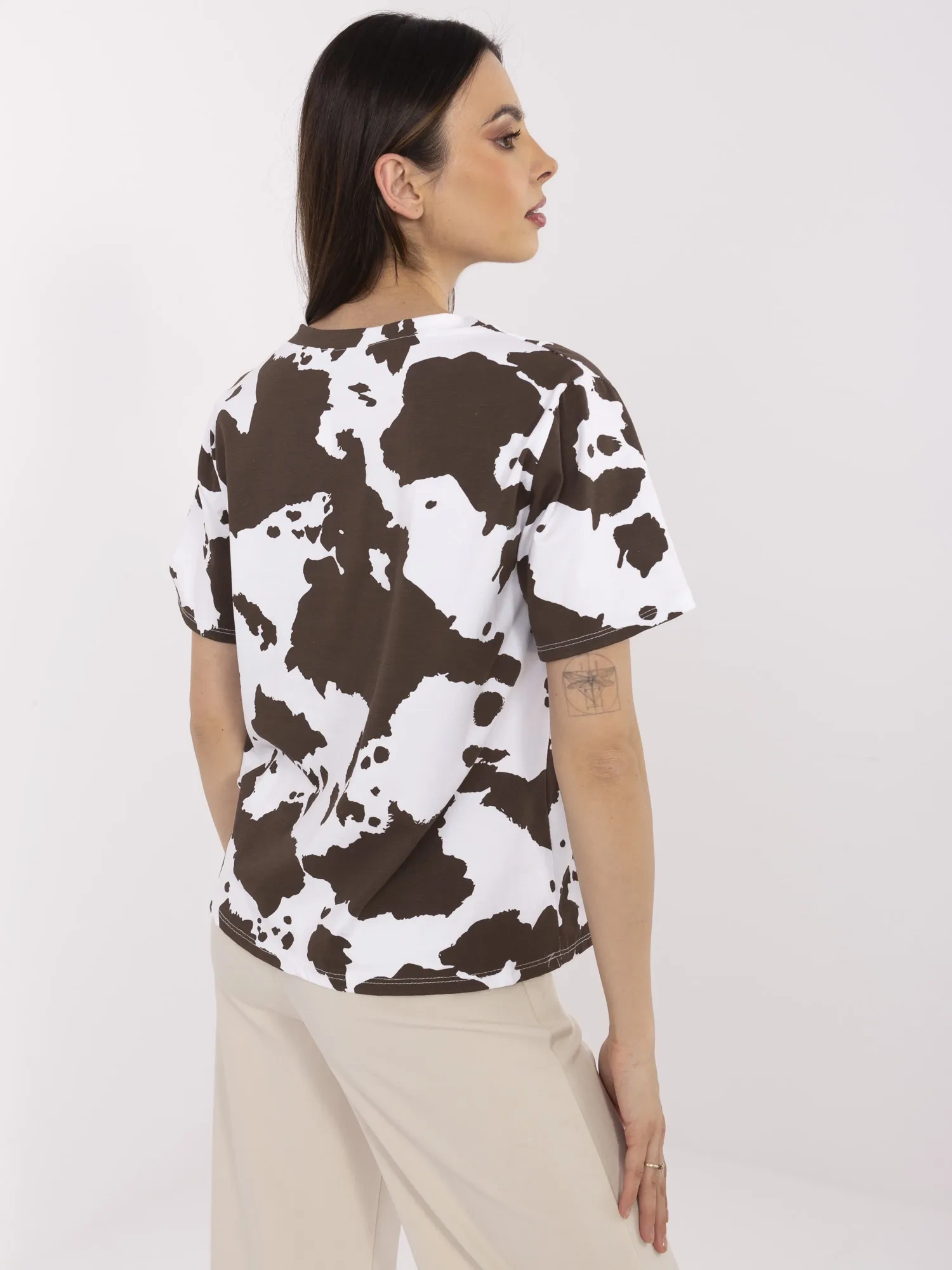 Brown and white women's t-shirt with cow spots.