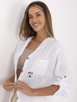 White muslin shirt with button closure.