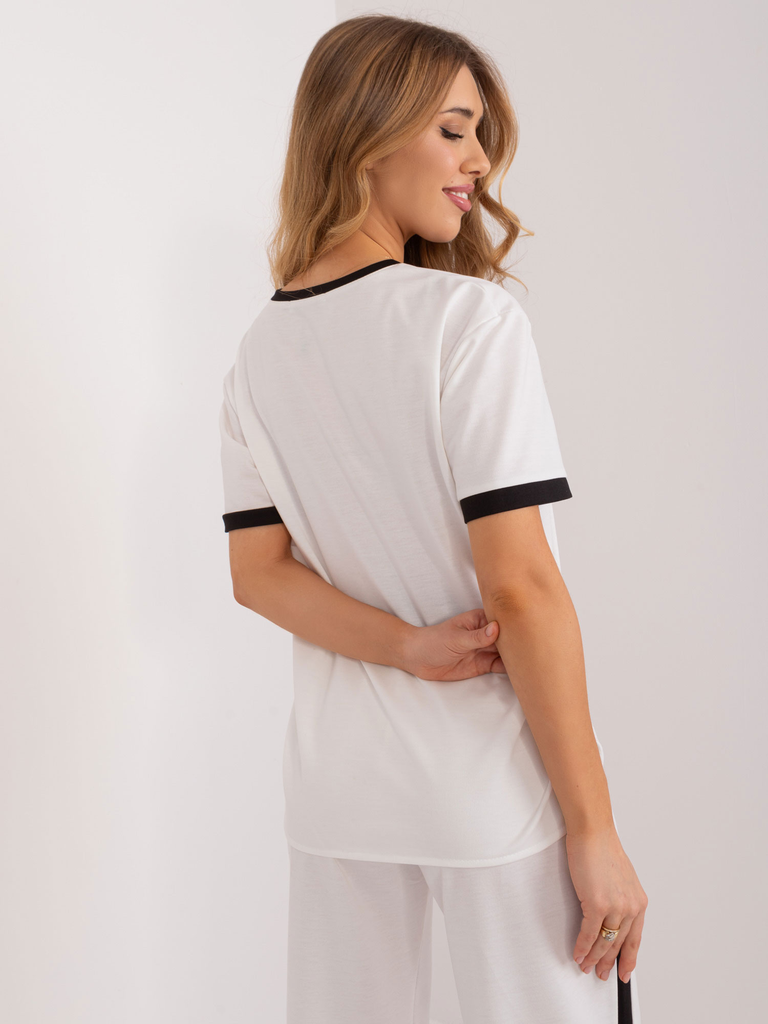 Wholesale Ecru women's blouse with decorative buttons.