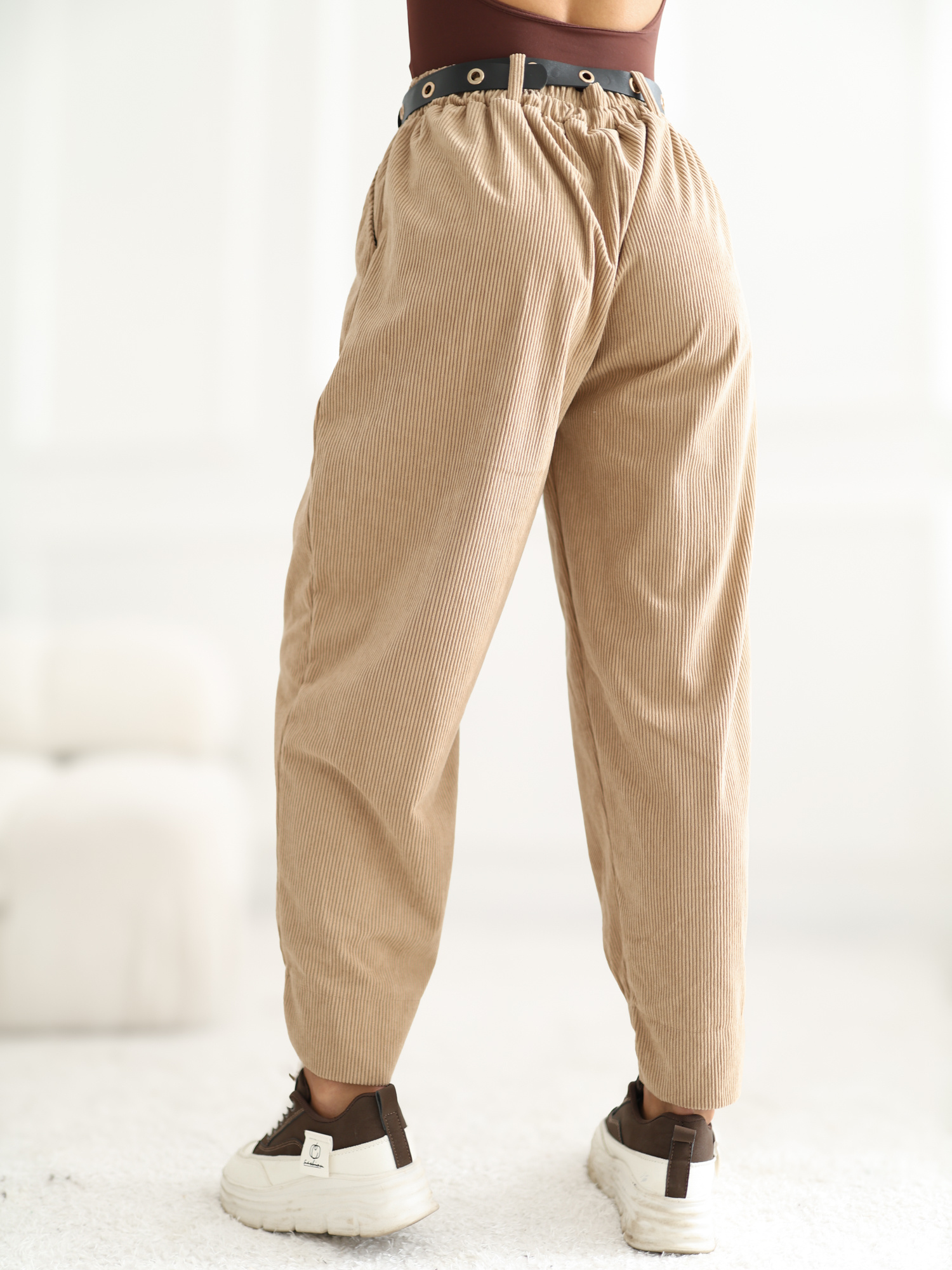 RUE PARIS Camel corduroy pants with an asymmetric leg.