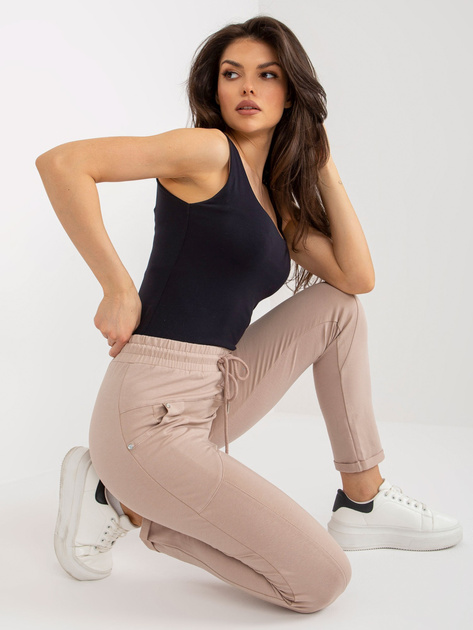 Hurt Beżowe damskie spodnie dresowe z kieszeniami