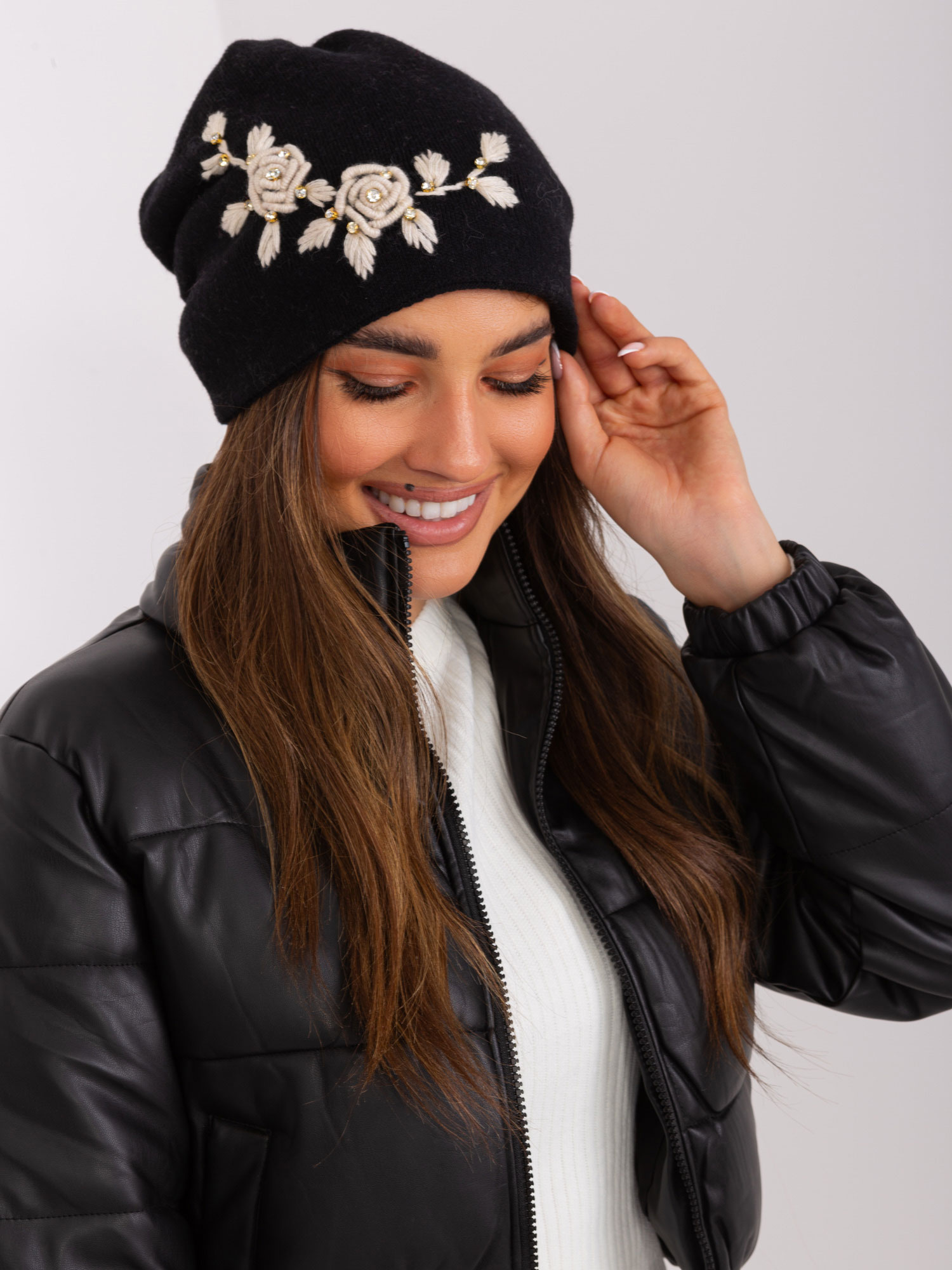 Black and beige knitted hat with appliqué and rhinestones