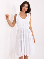 White muslin dress with straps.