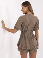 Brown muslin jumpsuit with buttons.