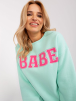 Hurt Miętowa dresowa bluza bez kaptura z napisem