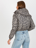 Pardavimas Tamsiai smėlinė dvipusė pūkinė striukė su gyvūnų raštu.