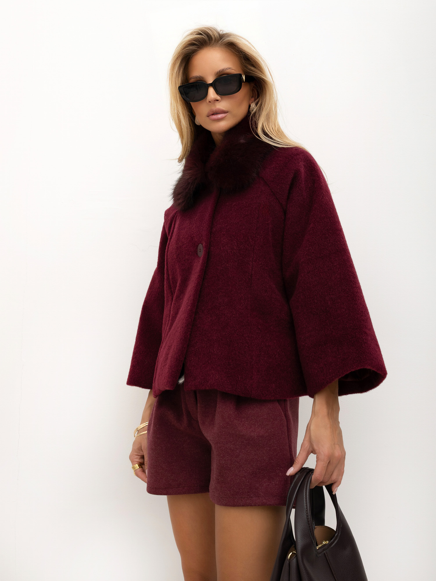 Burgundy trapeze coat with wide 3/4 sleeves.
