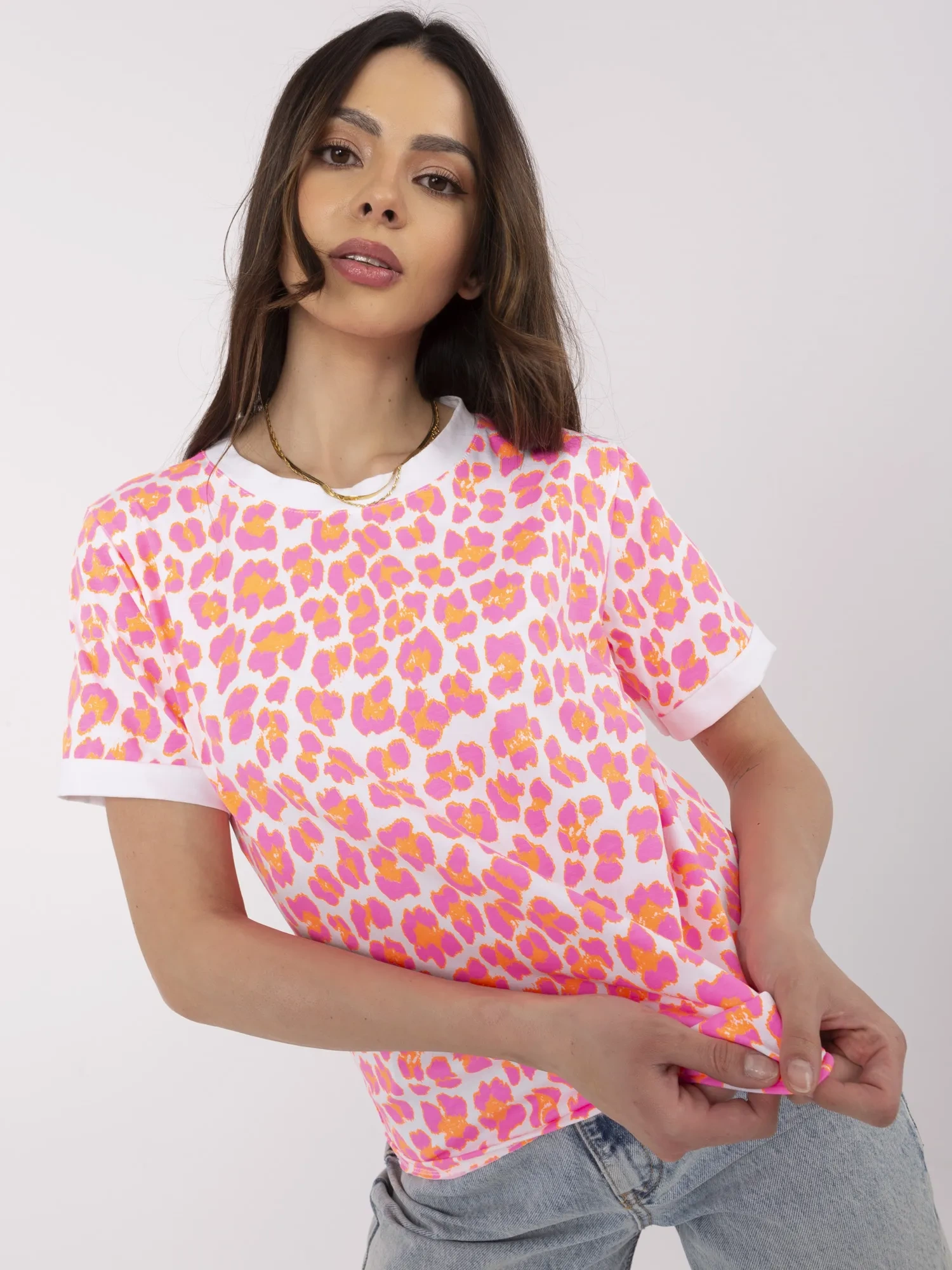 Fluorescent pink and white blouse with a round neckline.