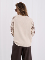 Light beige women's sweater with contrasting embroidery.