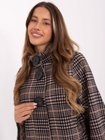 Light beige and black coat with large buttons.