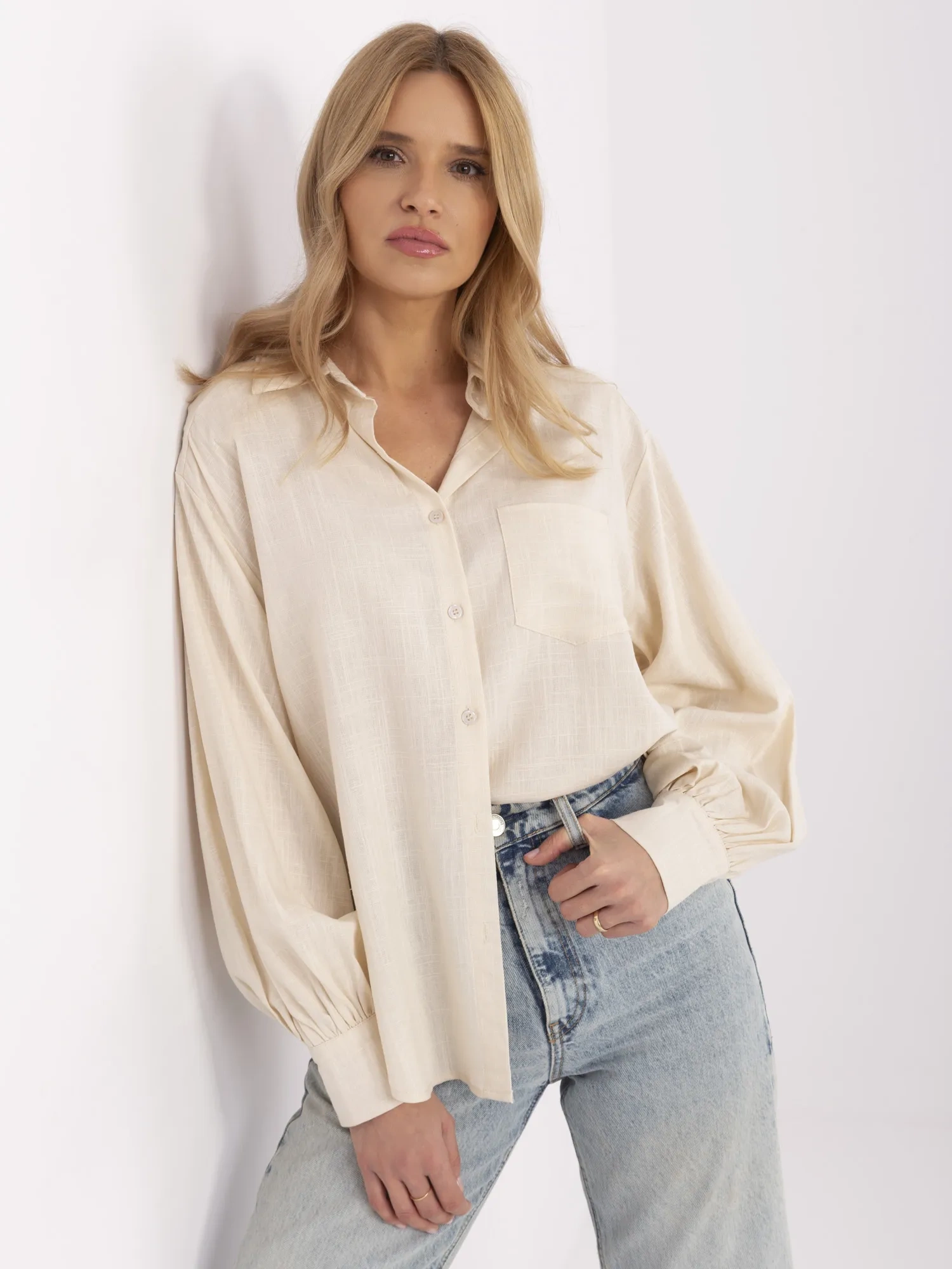 Light beige oversized shirt with puff sleeves.