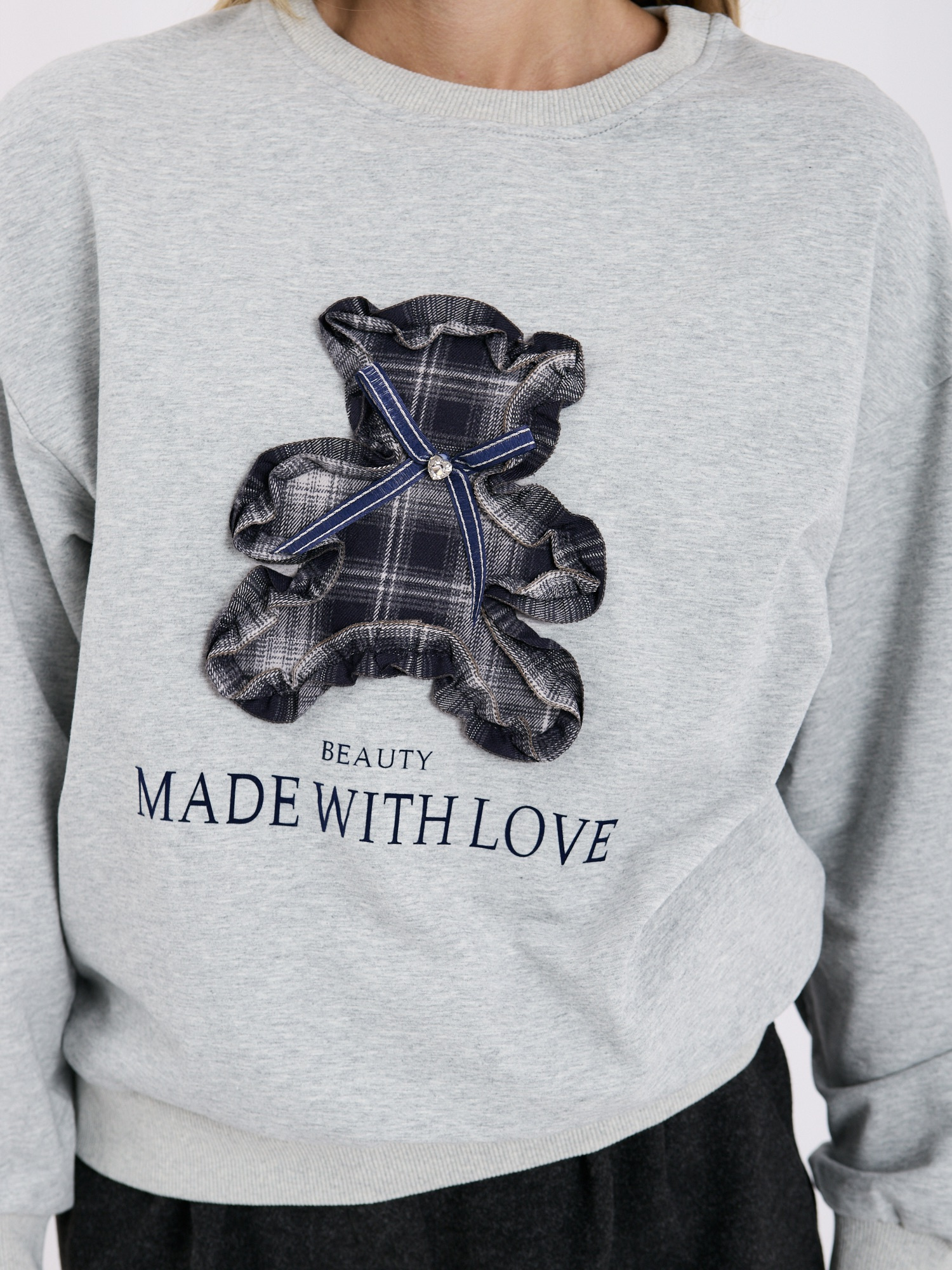 Gray sweatshirt with a bear patch.