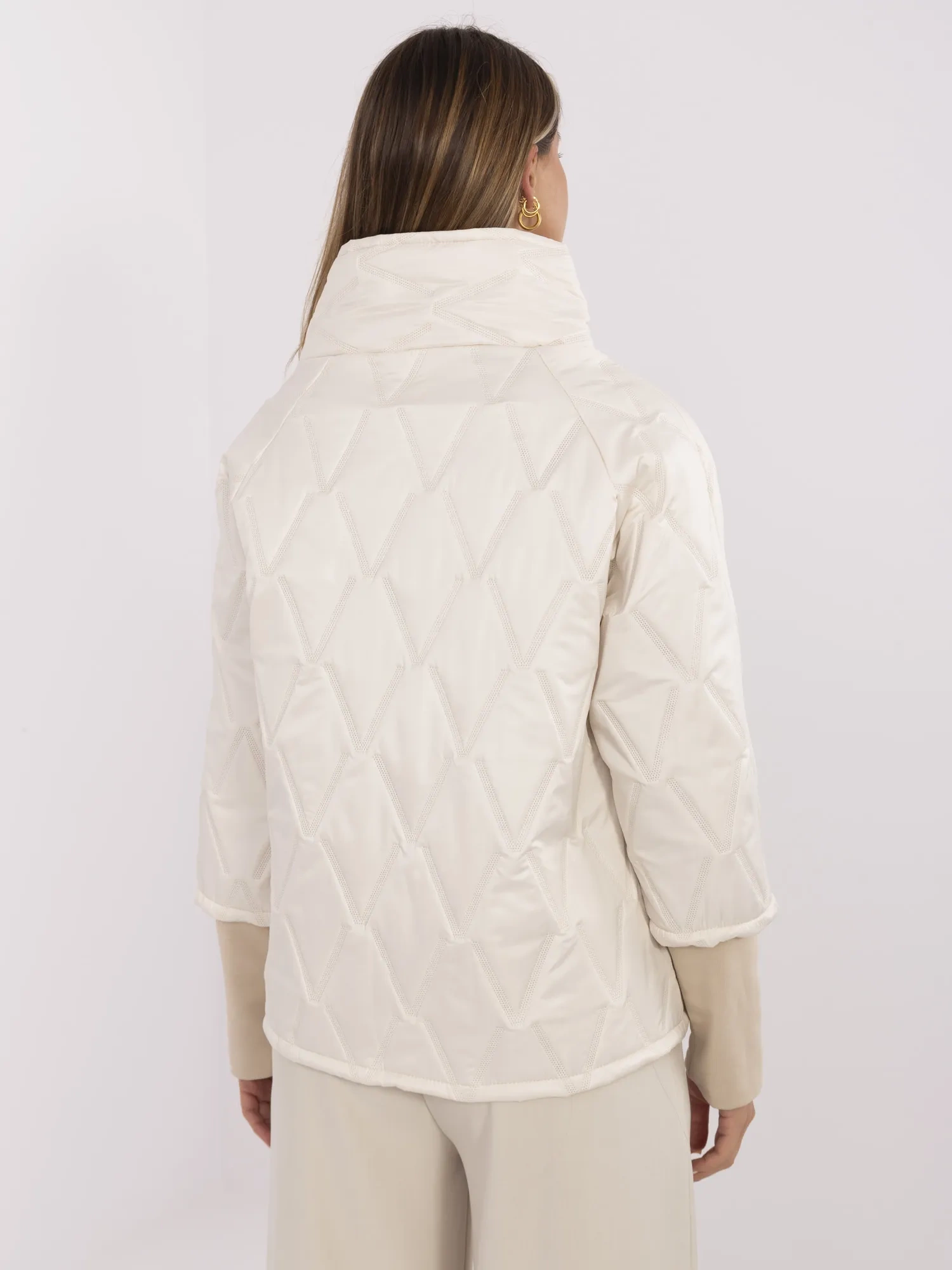 Light beige quilted jacket without a hood.