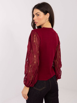 Burgundy sweater made of ribbed knit.