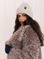 Light gray women's beanie hat with a heart patch.