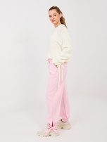 Jasnoróżowe dresowe spodnie wiązane w kostce