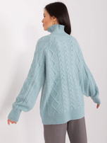 Mint sweater with braids and ribbing.