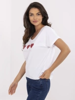 Weißes T-Shirt mit Herz-Applikationen.