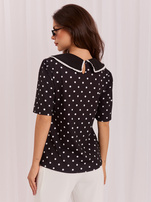 Black women's blouse with a decorative collar.