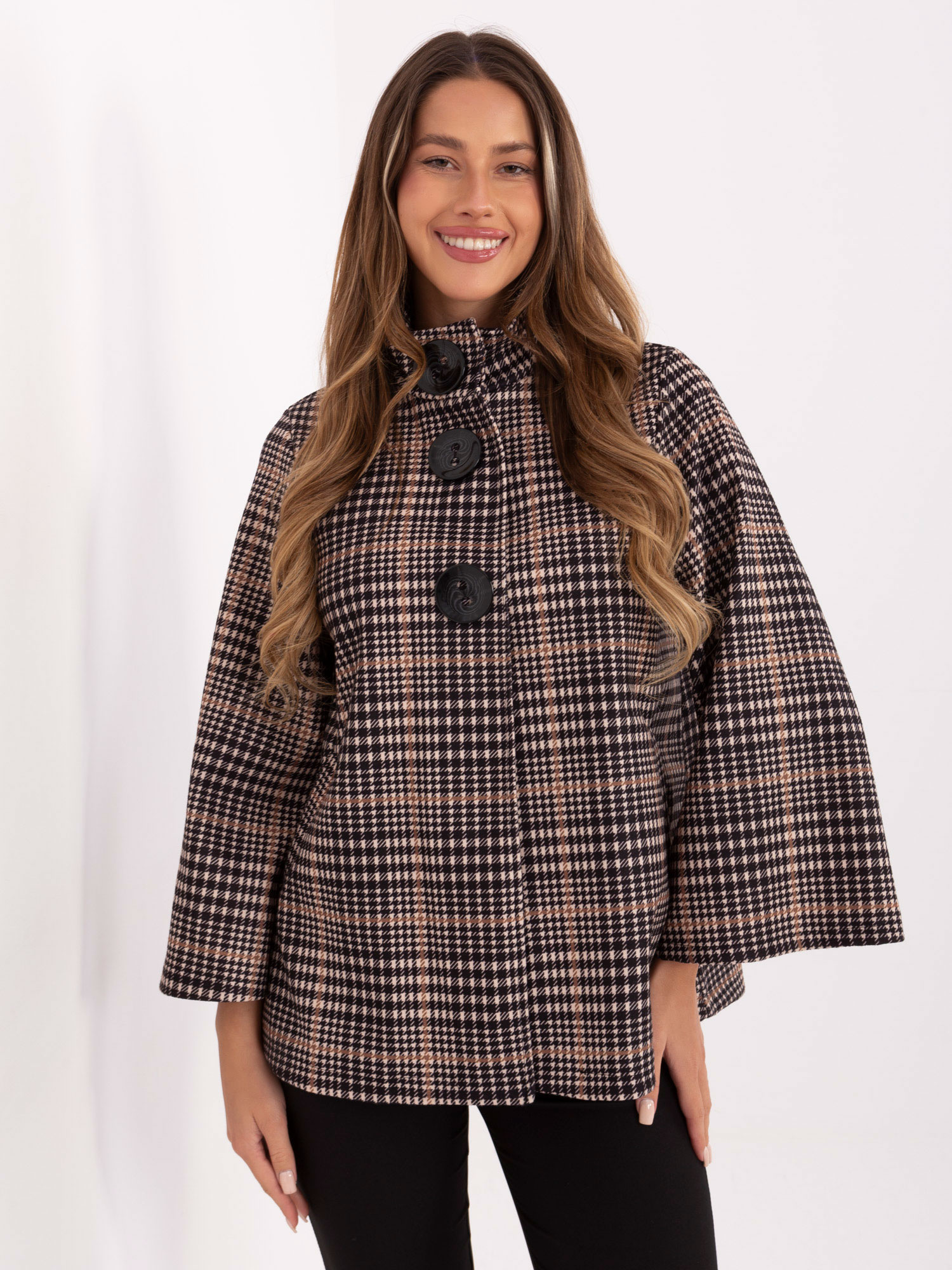 Light beige and black coat with large buttons.