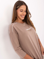 Dark beige women's blouse with a print.