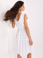 White muslin dress with straps.