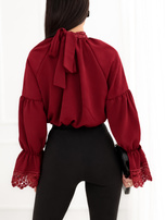 Burgundy blouse with a neck tie.