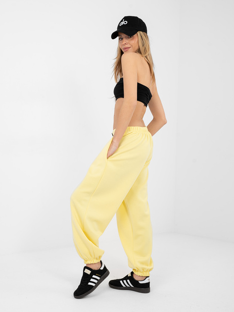 Jasnożółte dresowe spodnie z ozdobnym guzikiem