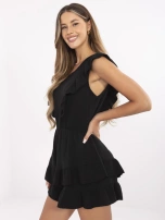 Black muslin jumpsuit with ruffles.
