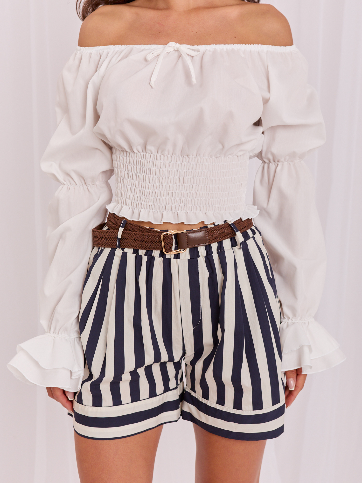 White women's off-shoulder blouse made of cotton.