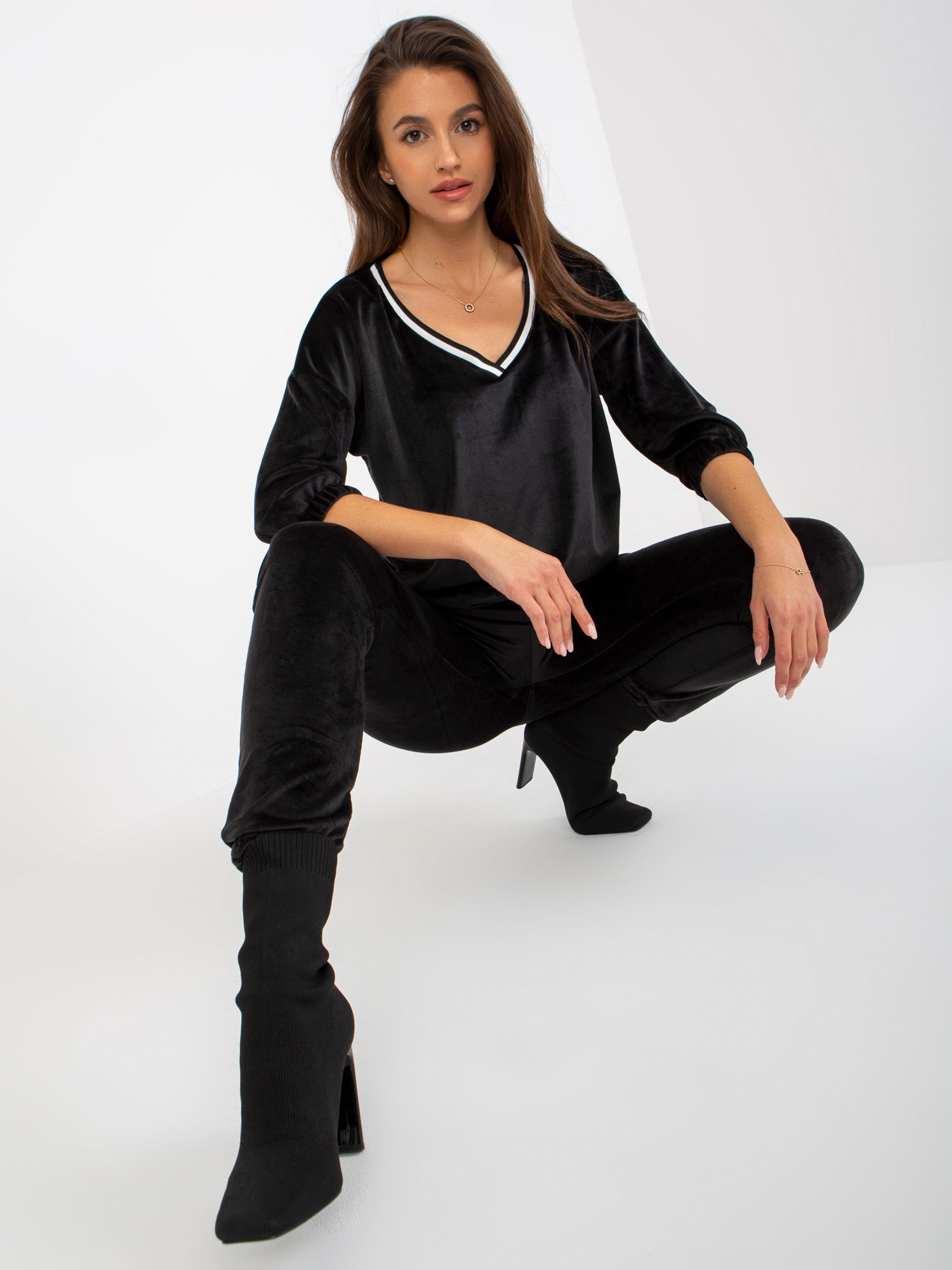 Juodasis dviejų dalių veliūro komplektas su 3/4 ilgio rankovėmis.