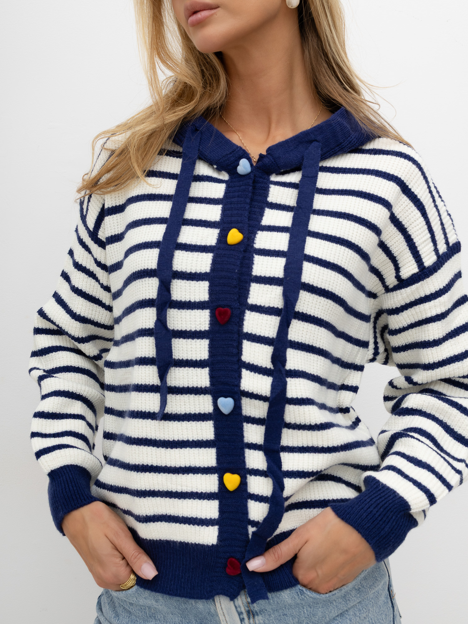 Navy sweater with decorative heart-shaped buttons.