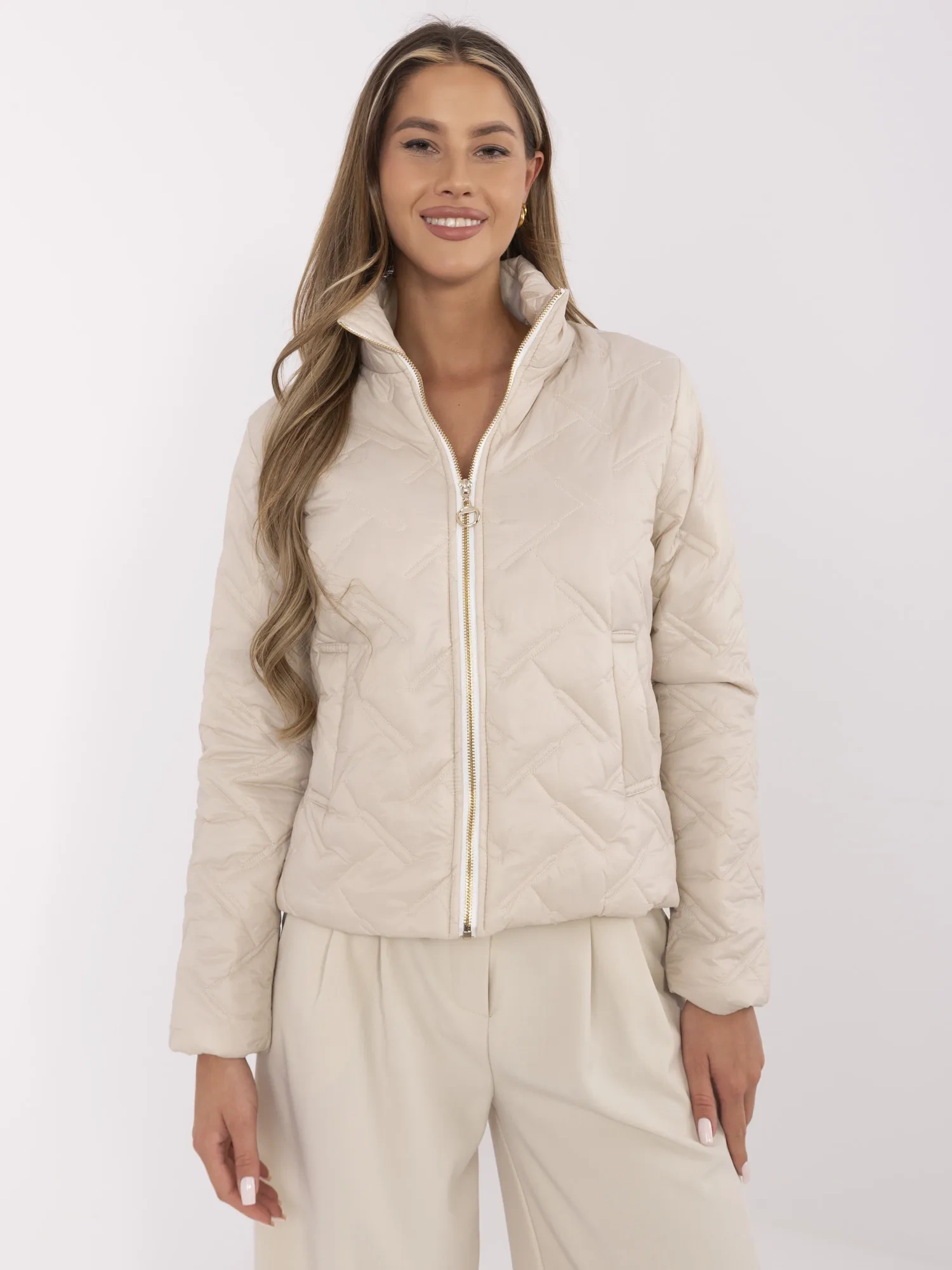 Beige quilted women's jacket with a stand-up collar.