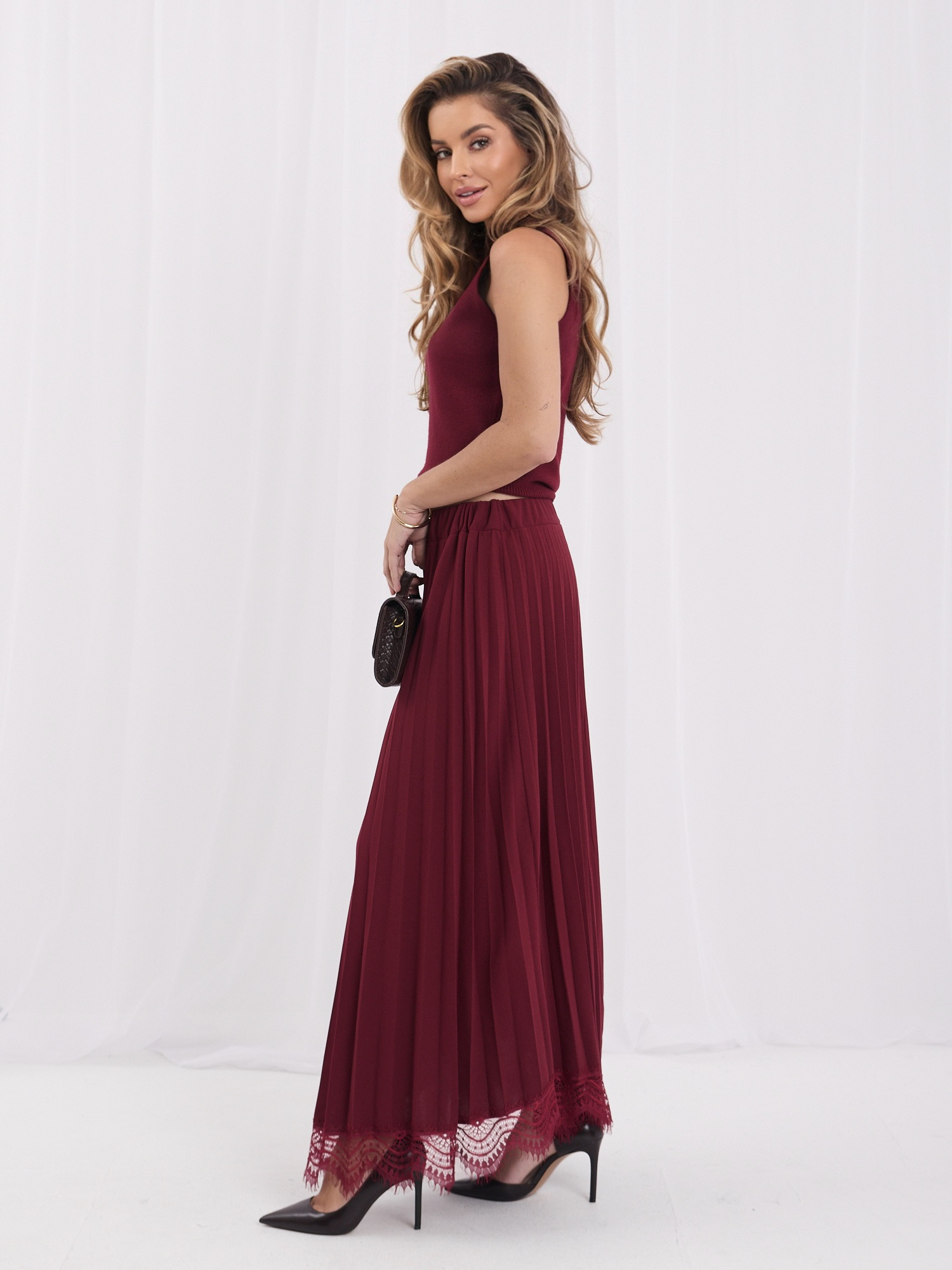 Burgundy maxi skirt with decorative finish.