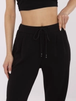 Black pants made of pleasant-to-touch material.
