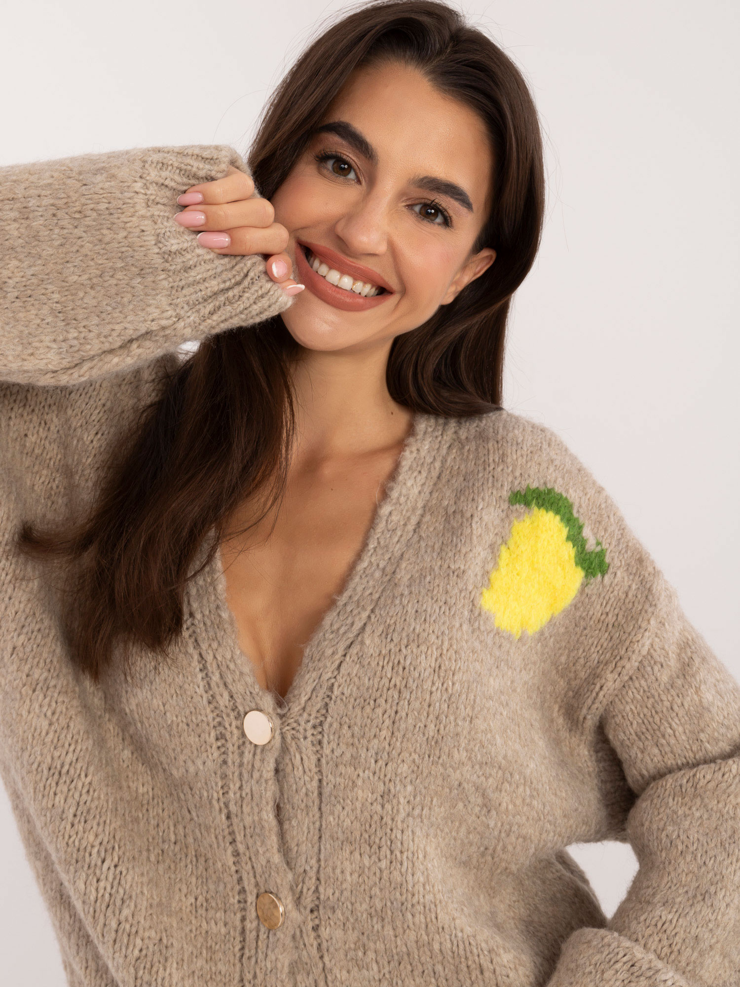 Beige zip-up sweater with a print on the back.