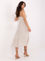 Beige muslin dress with straps.