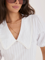 White flared dress with a collar.