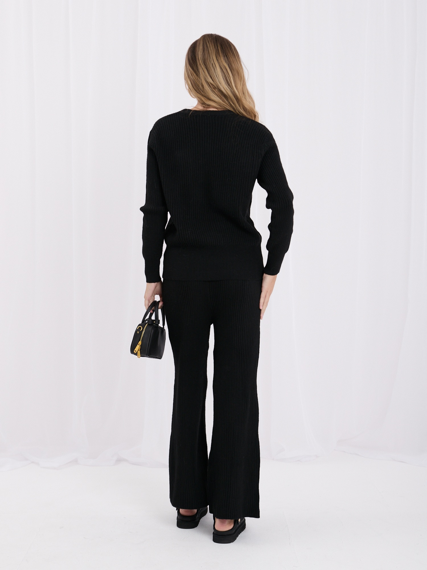 Black two-piece set made of ribbed knit.