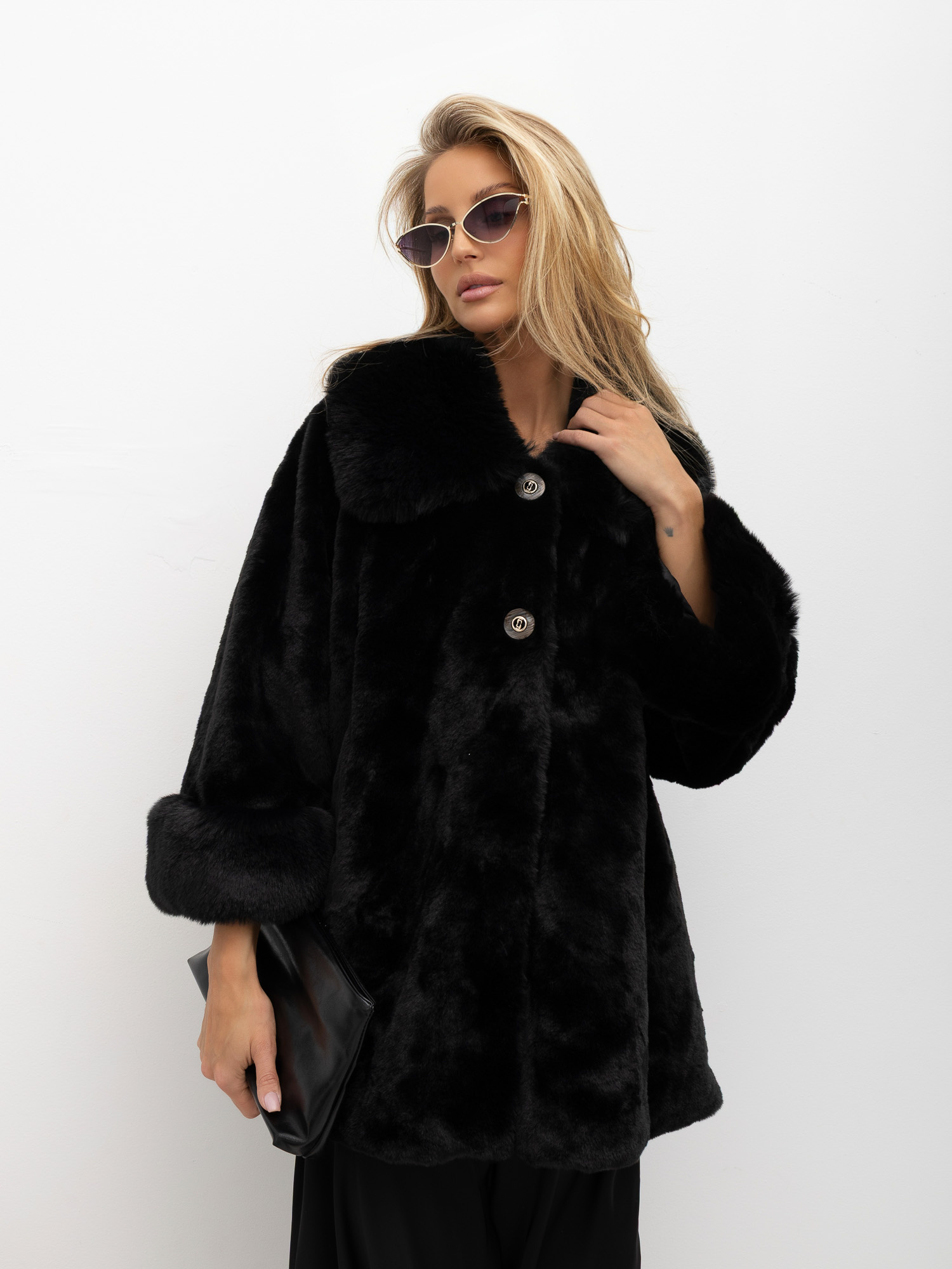 Black short coat made of eco-fur with wide sleeves.