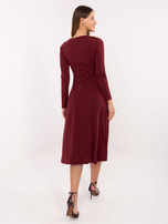 Burgundy trapeze dress with draping.