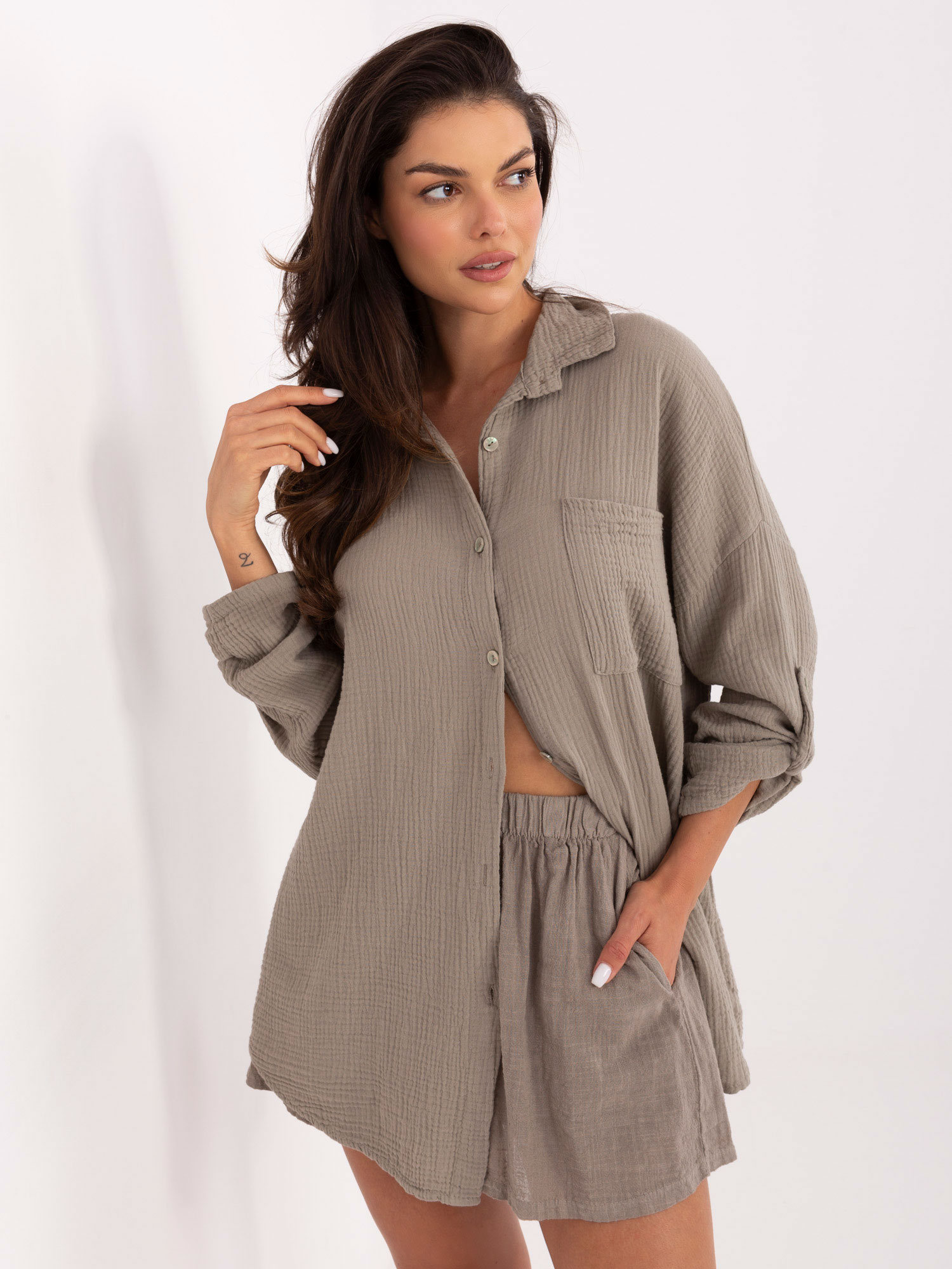 Dark beige button-up muslin shirt.