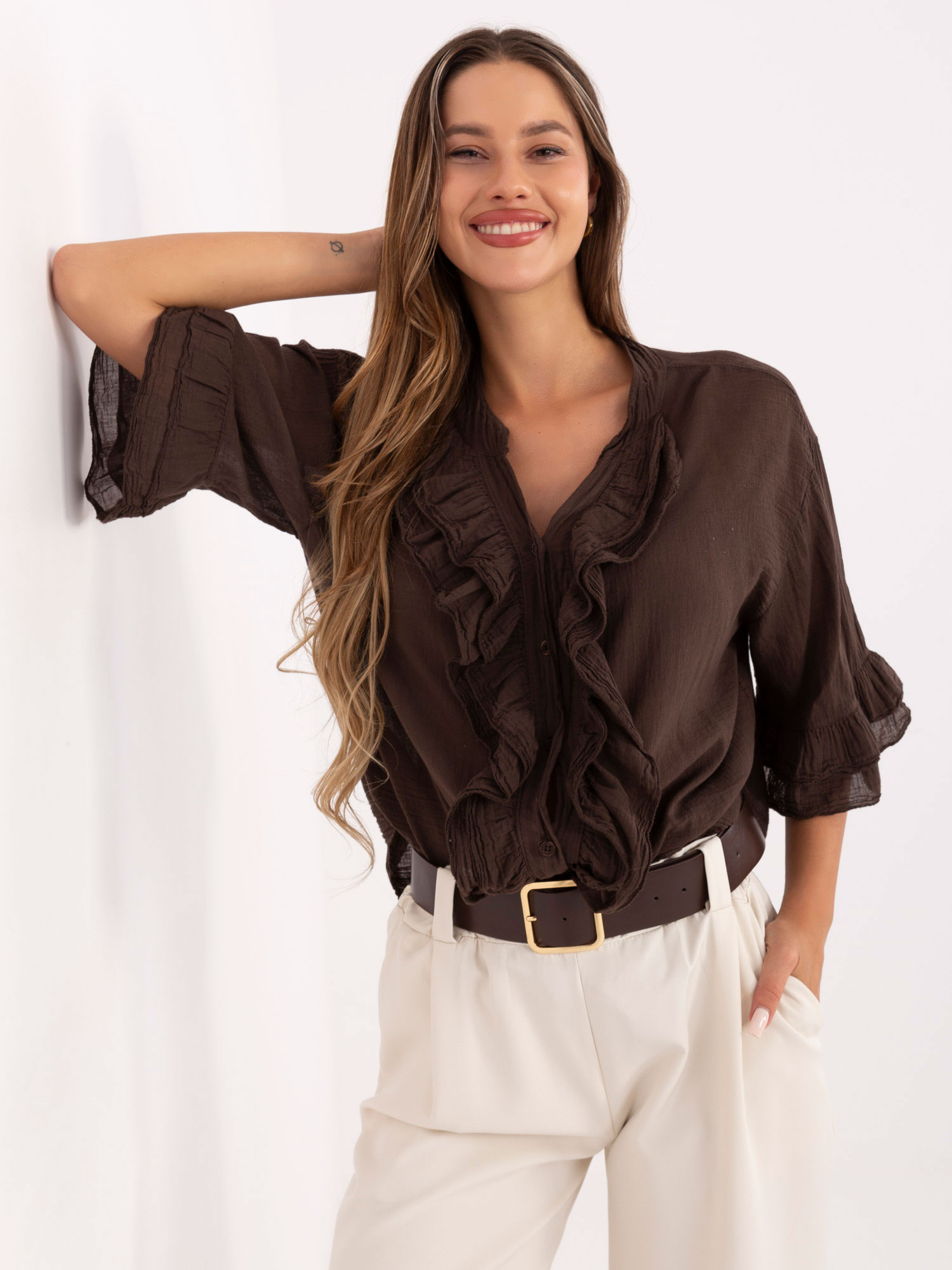 Dark brown flowing shirt with a ruffle.