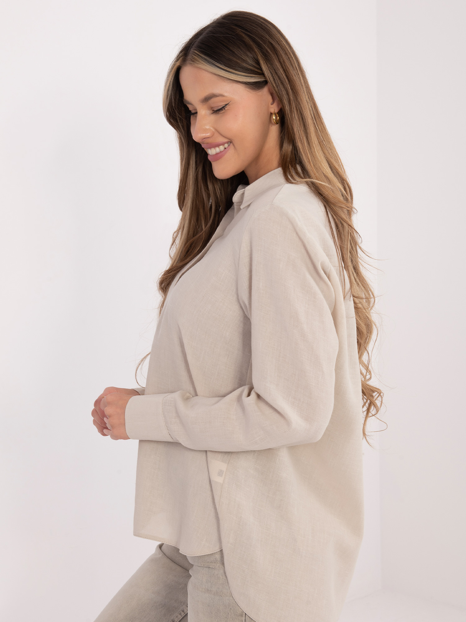 Beige women's shirt with a longer back.