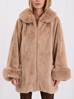 Beige women's fur coat with impressive sleeves.
