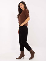 Black women's mom jeans with a belt.