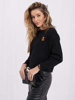 Black women's sweater with an embroidered bear.