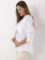 White muslin shirt with button closure.