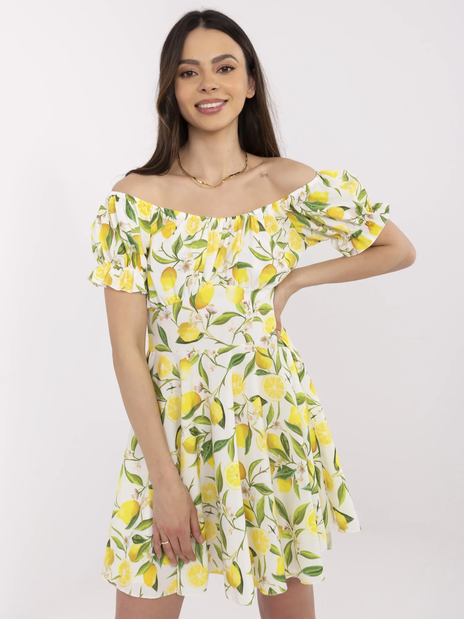 Ecru-yellow off-the-shoulder dress with lemons.
